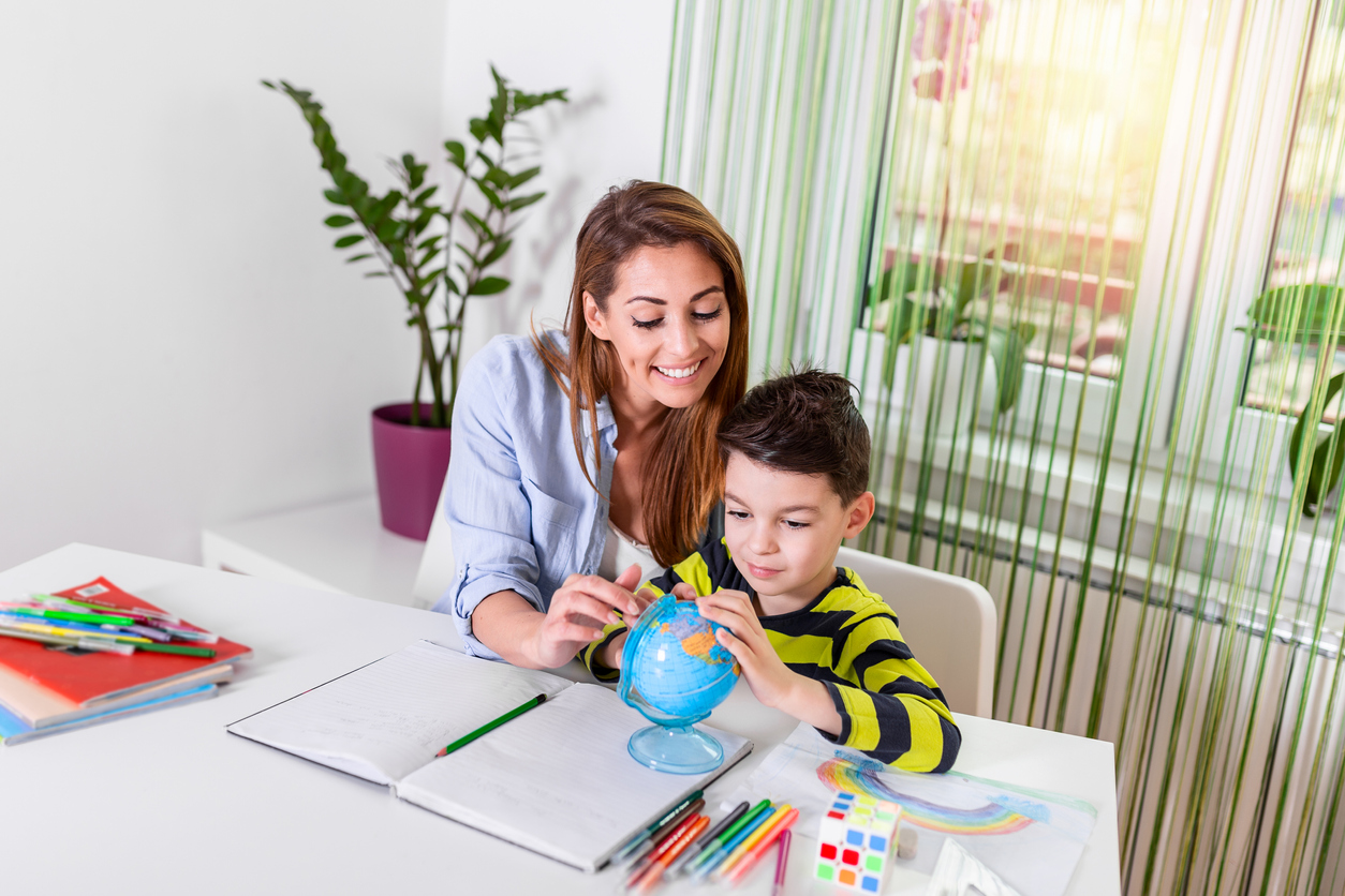 Learning from home, nanny and kid doing homework.